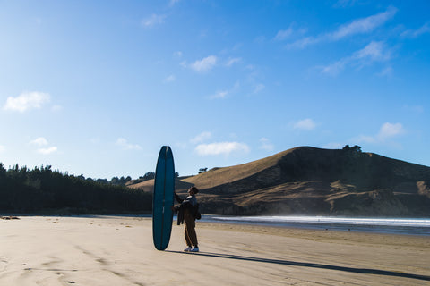 Kaimana in New Zealand with his Surfboard 